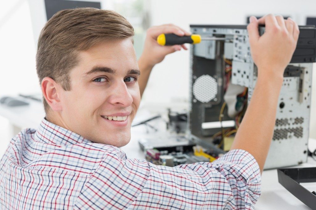 Technician working on a broken computer