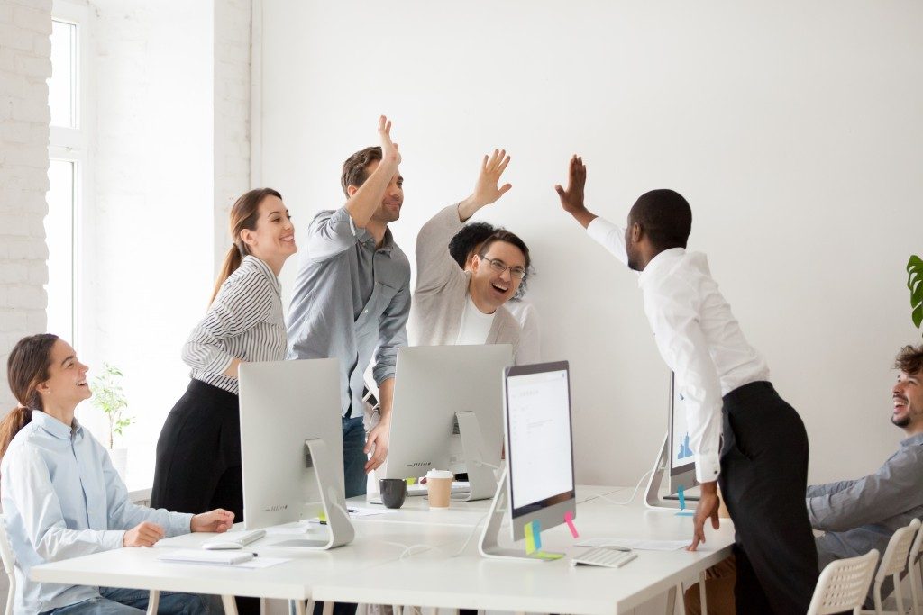 Employees giving each other a high five