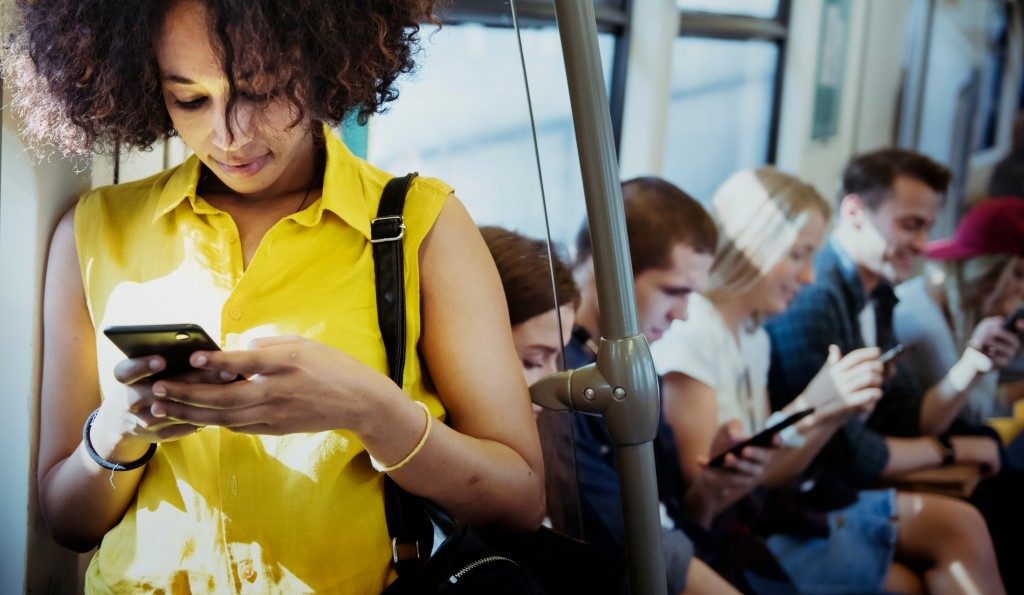 people browsing online in a train