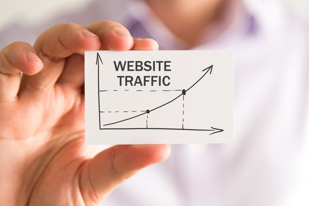 man holding a card that shows a chart of website traffic